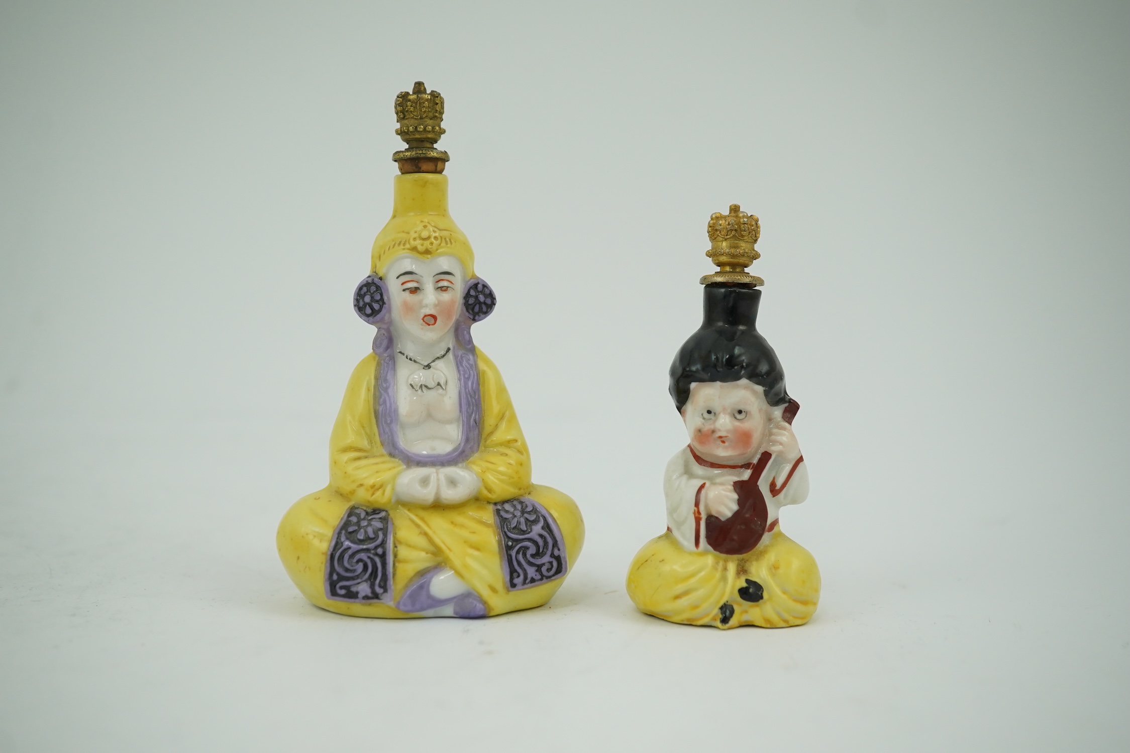 Two Continental porcelain figural scent bottles with gilt stoppers, largest 9cm high. Condition - good